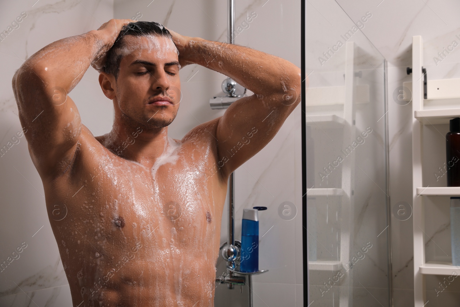 Photo of Man taking shower with gel at home