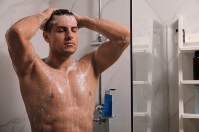 Photo of Man taking shower with gel at home