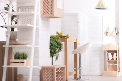 Photo of Modern eco style kitchen interior with wooden crates and shelves