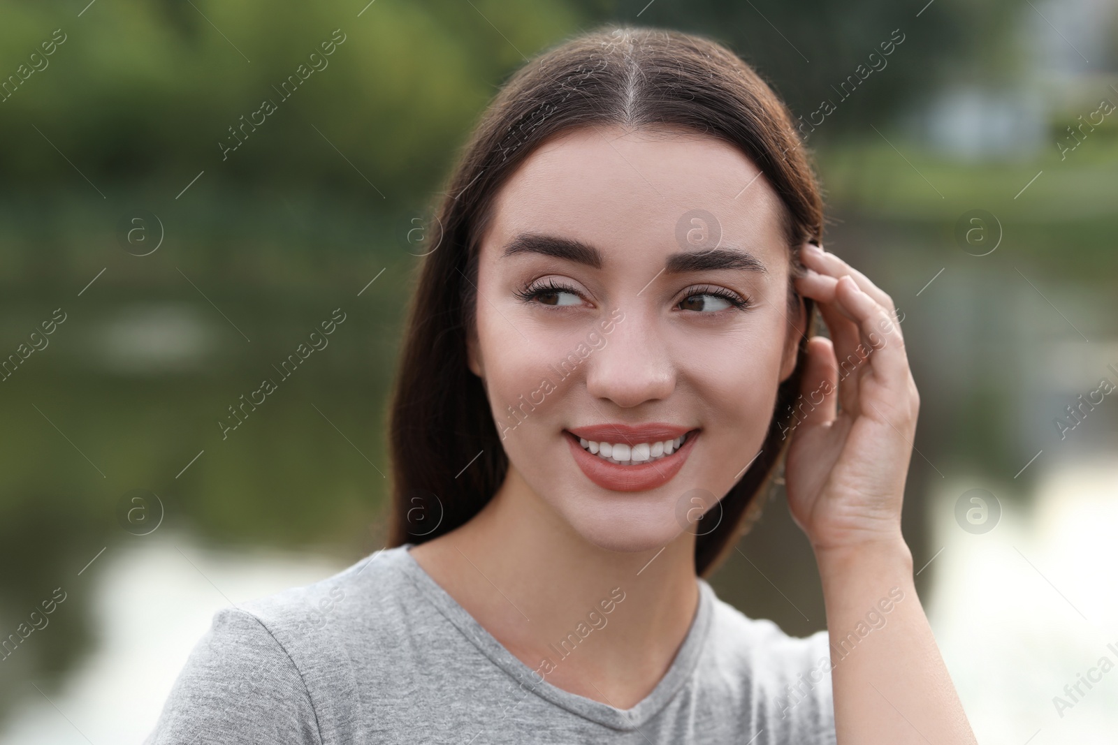 Photo of Portrait of beautiful woman outdoors. Attractive lady smiling and posing for camera