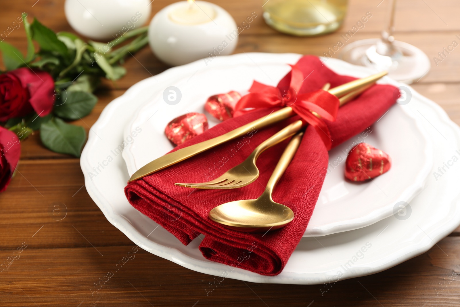 Photo of Beautiful table setting for Valentine's Day dinner on wooden background, closeup