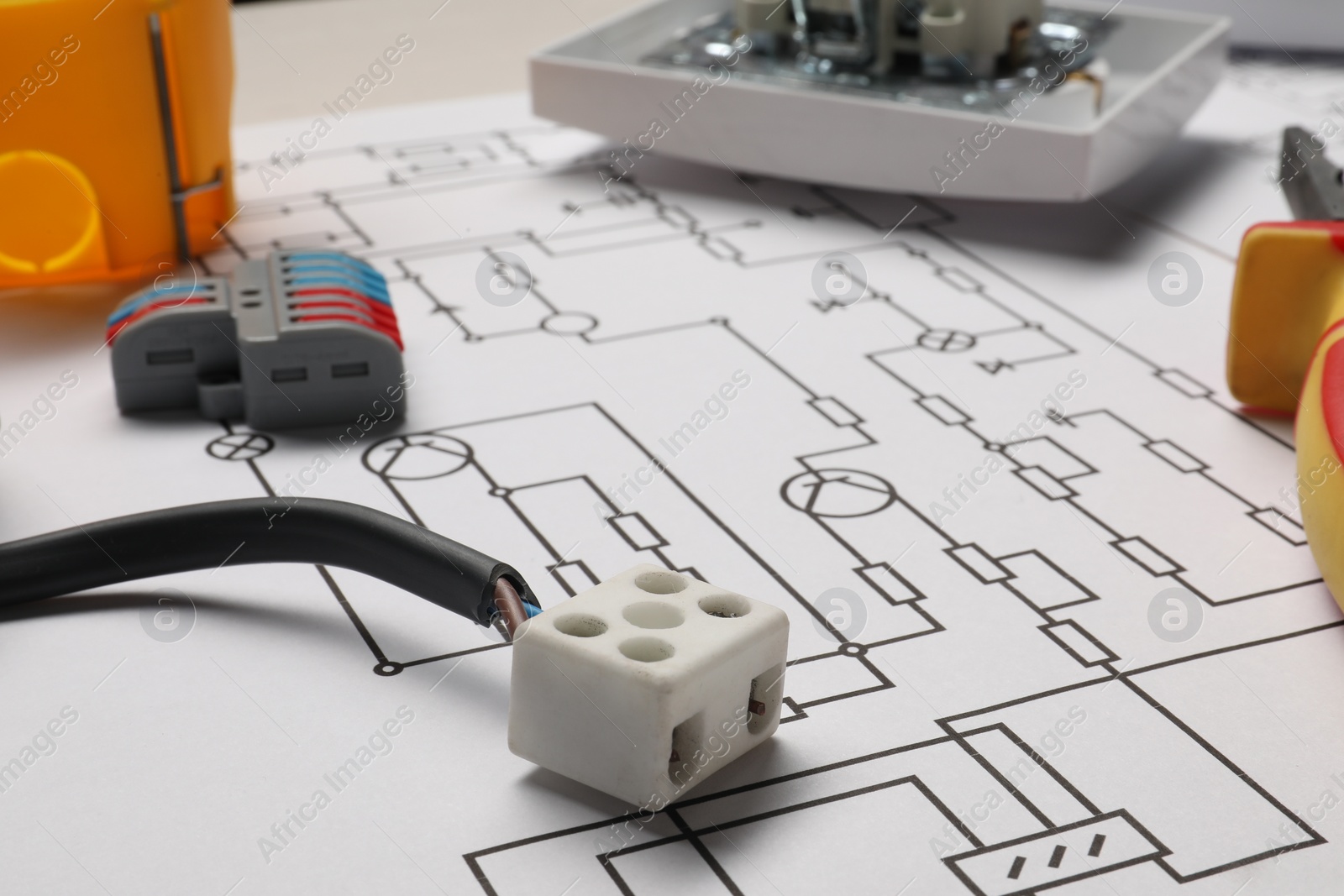 Photo of Wiring diagram and different electrician's equipment on table, closeup