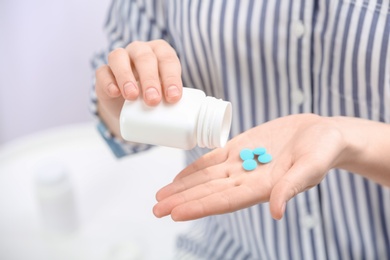 Photo of Young woman with bottle of pills, closeup