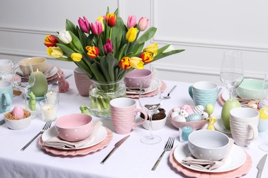 Photo of Festive table setting with beautiful flowers. Easter celebration