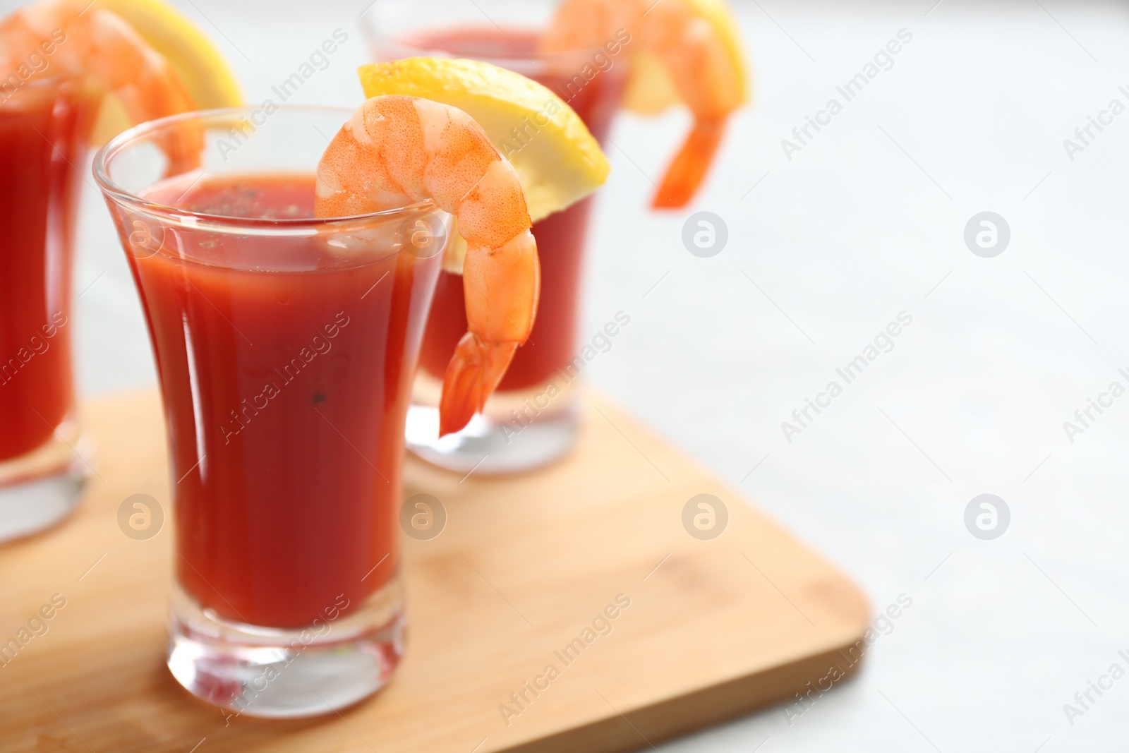 Photo of Delicious shrimp cocktail with tomato sauce served on  table, closeup. Space for text