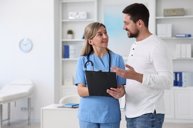 Photo of Professional doctor working with patient in hospital, space for text