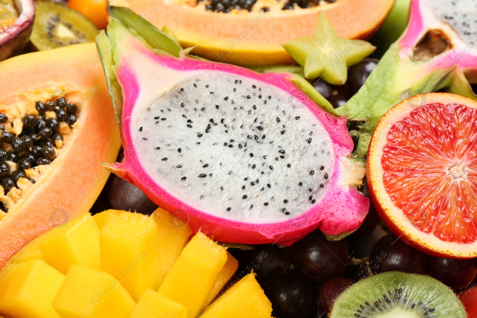 Photo of Many different delicious exotic fruits as background, closeup