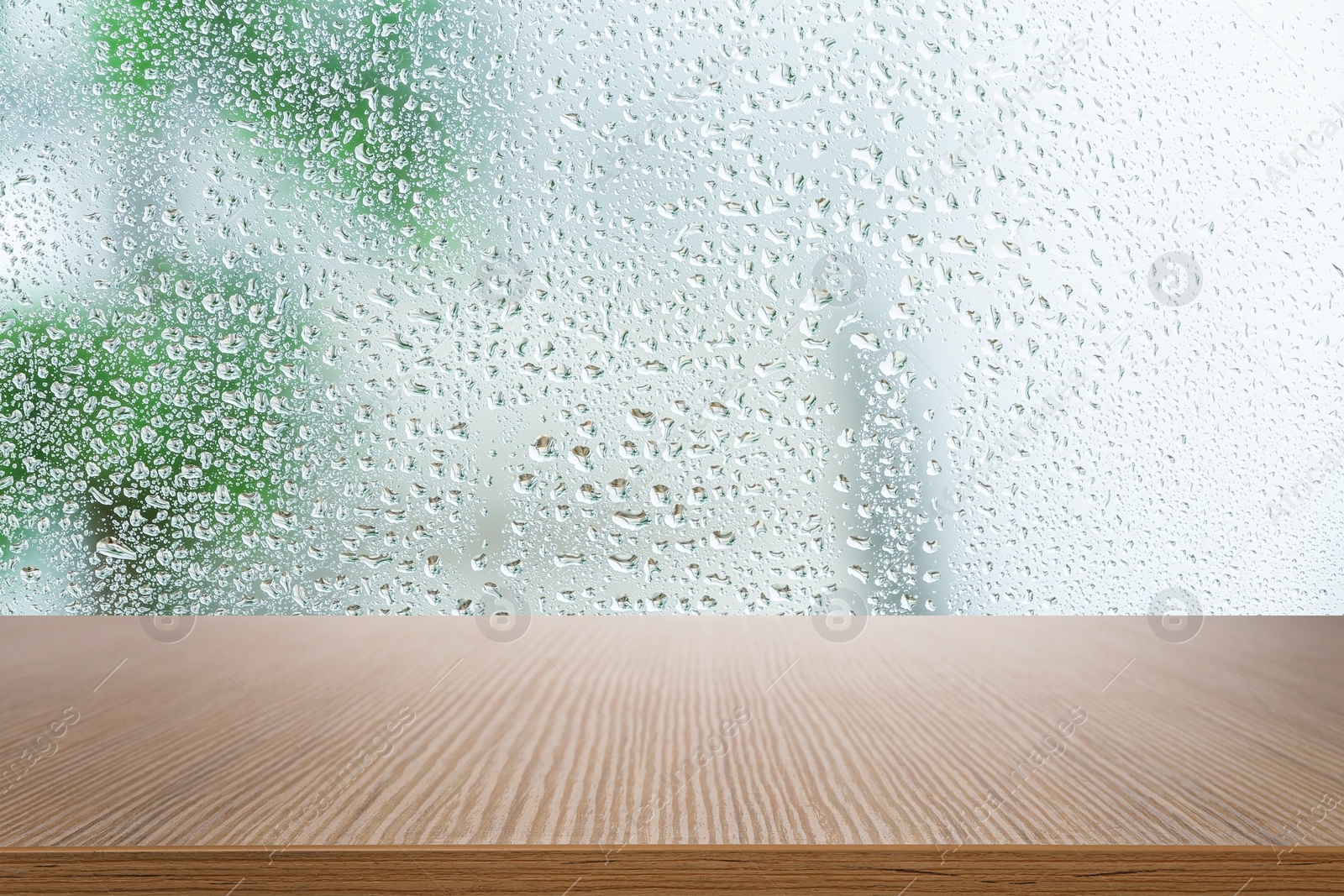 Image of Wooden table near window on rainy day