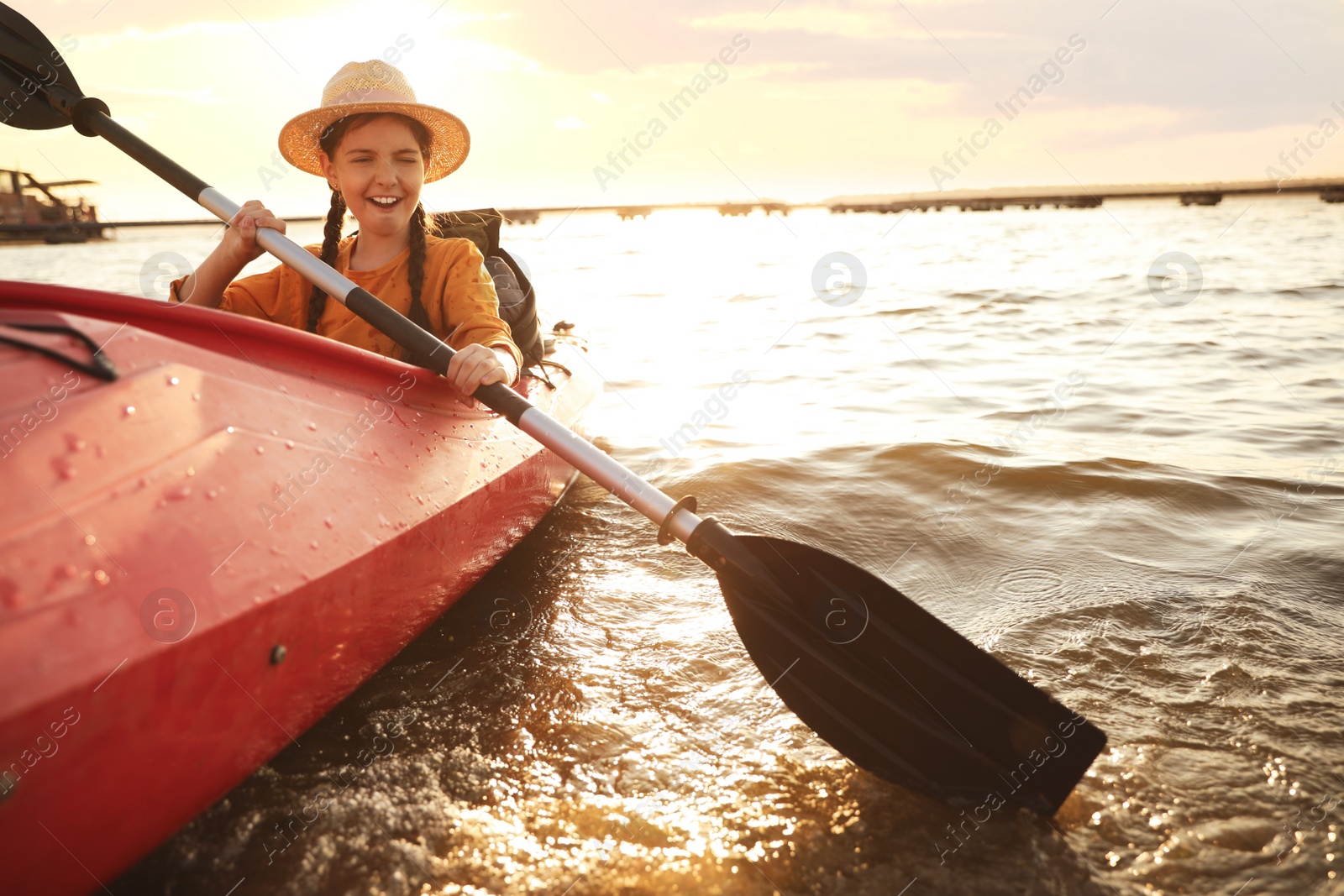 Photo of Happy girl kayaking on river. Summer camp activity