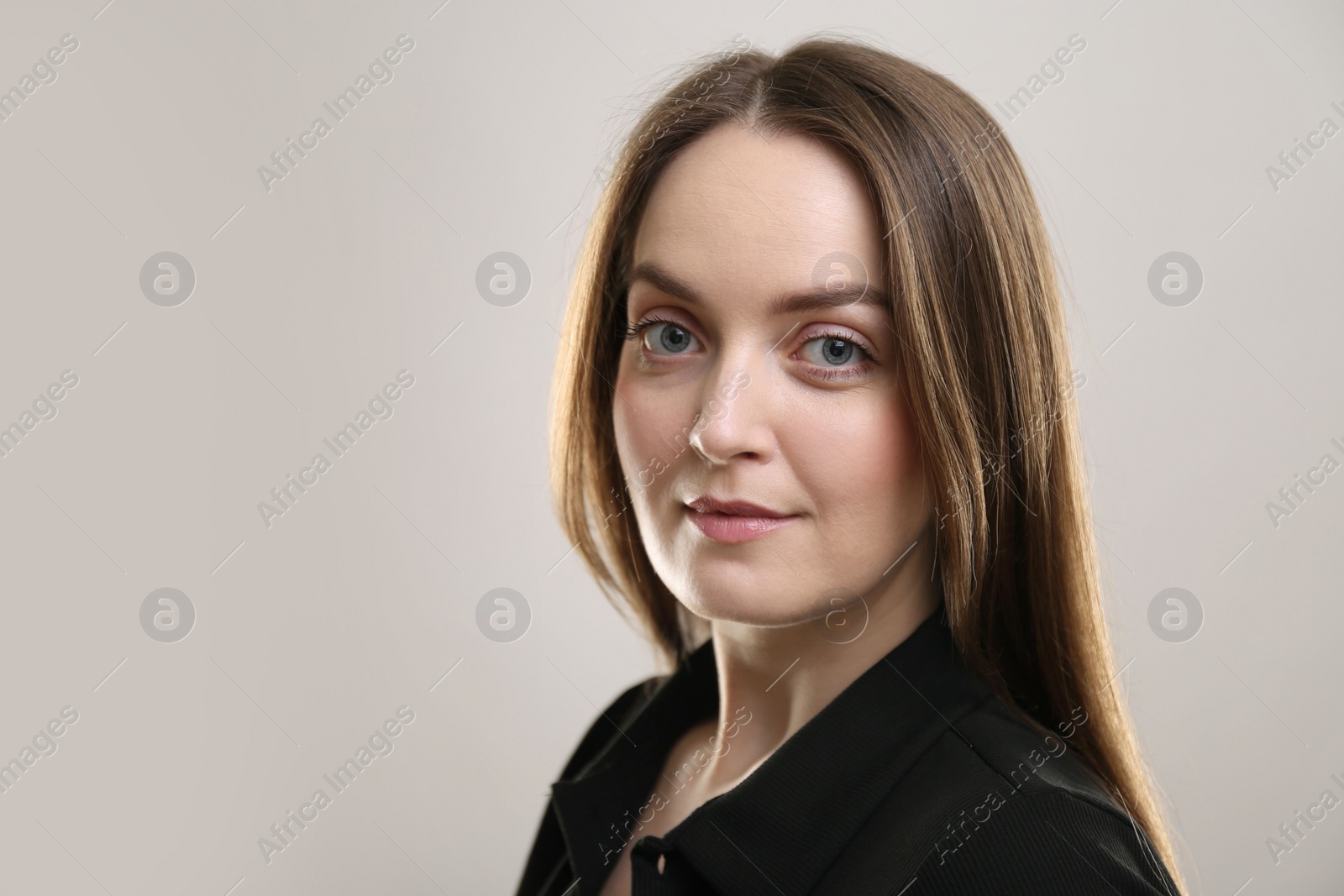 Photo of Portrait of beautiful young woman on beige background. Space for text