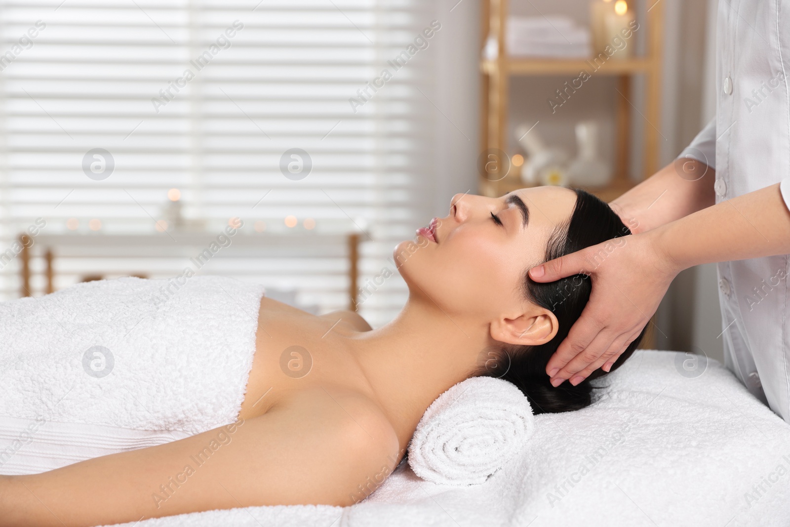 Photo of Beautiful woman receiving massage in beauty salon, closeup