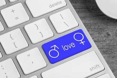 Love button on laptop keyboard, closeup. Online dating site