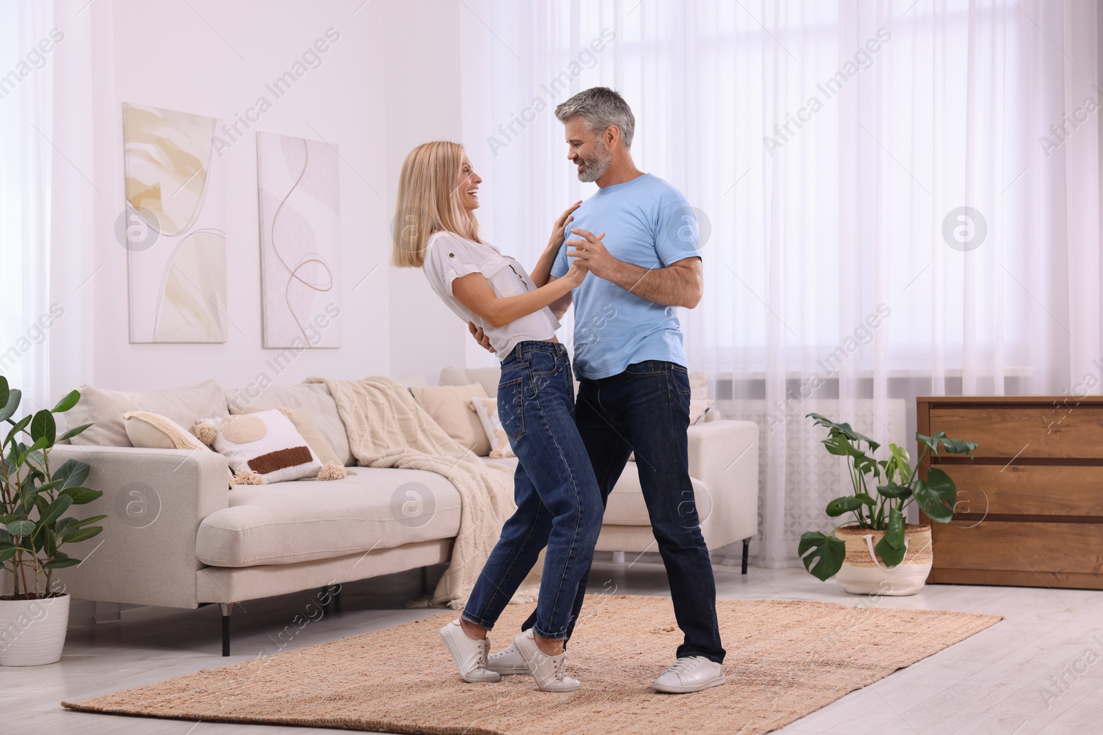 Photo of Happy affectionate couple dancing at home, space for text. Romantic date