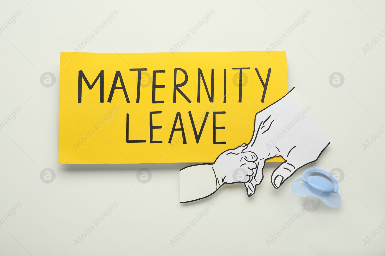 Photo of Note with words Maternity Leave, baby pacifier and paper cutout of hands on white background, flat lay
