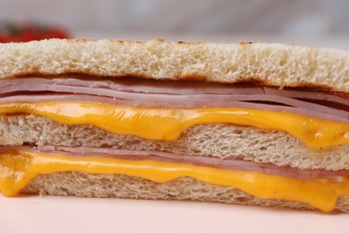 Photo of Delicious grilled sandwich with ham and cheese on table, closeup