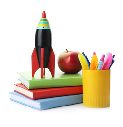 Photo of Bright toy rocket and school supplies on white background