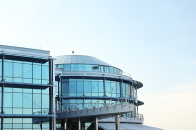 Modern building with tinted windows against sky. Urban architecture