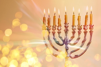 Silver menorah with burning candles on light background, closeup. Hanukkah celebration