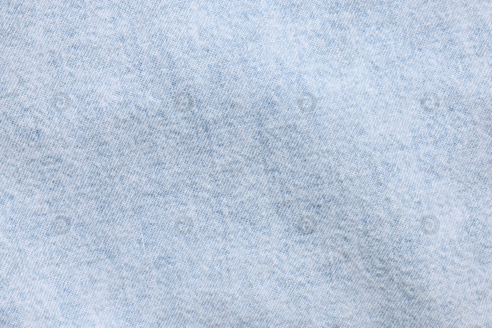 Photo of Texture of light blue fabric as background, top view