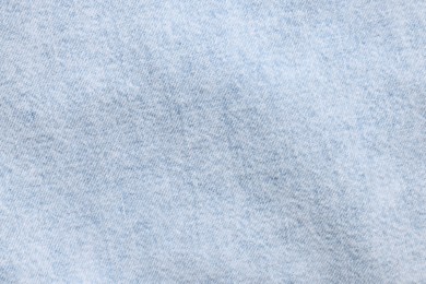 Photo of Texture of light blue fabric as background, top view