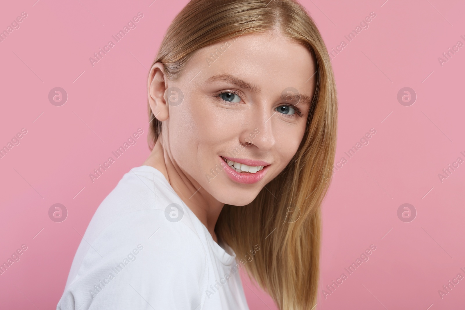 Photo of Portrait of beautiful young woman on pink background