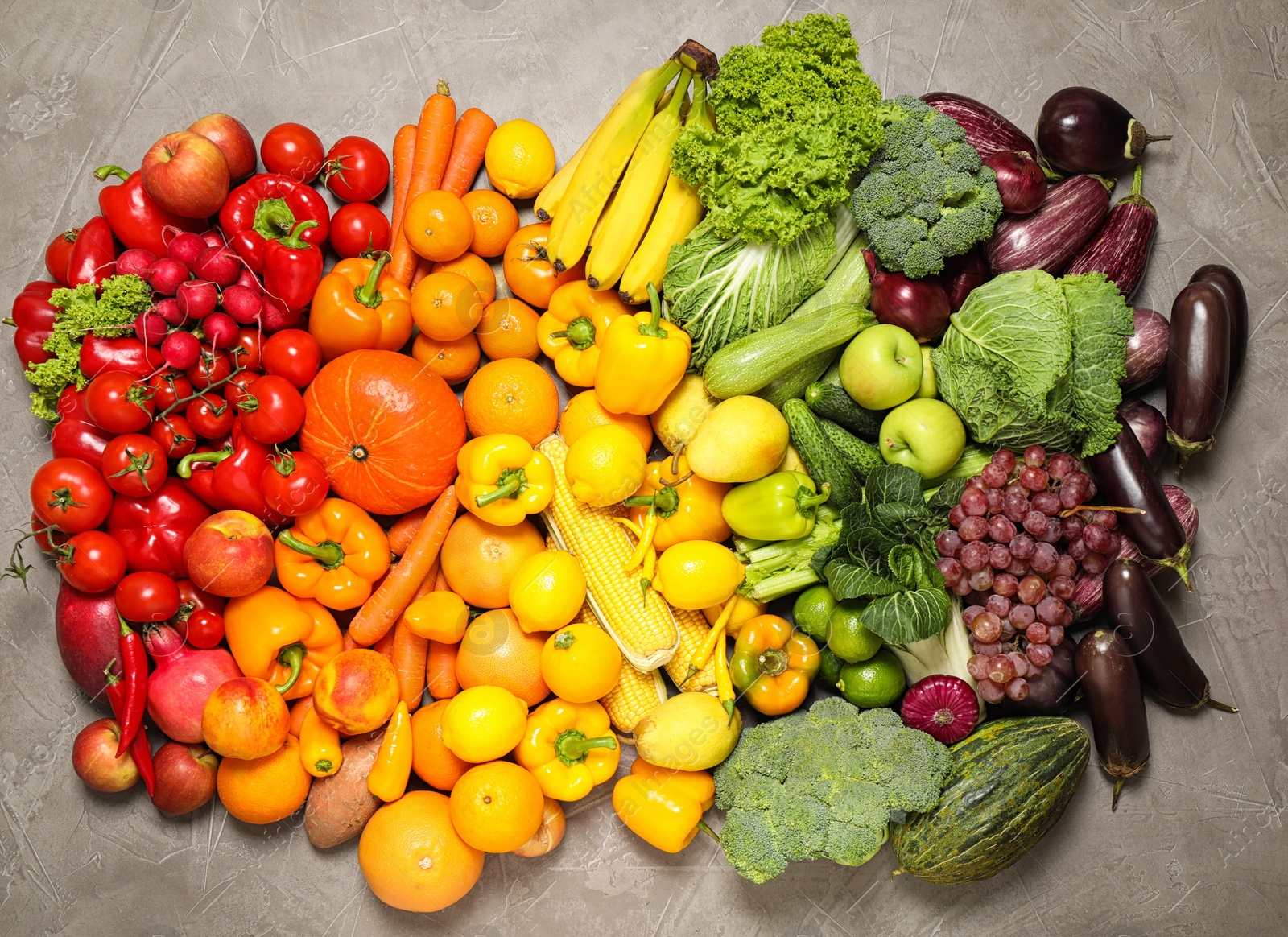 Photo of Assortment of organic fresh fruits and vegetables on grey background, flat lay