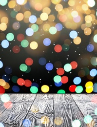 Image of Empty wooden surface and blurred Christmas lights on background, bokeh effect