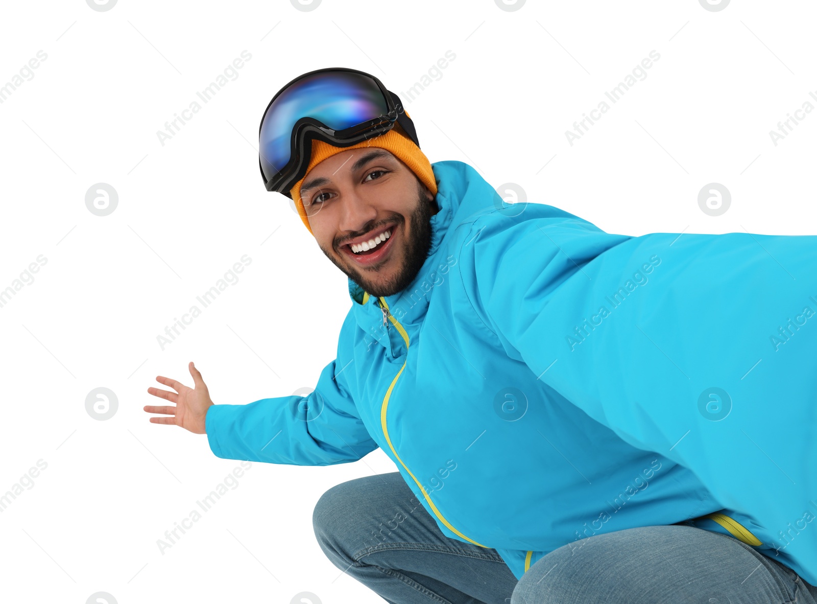 Photo of Smiling young man with ski goggles taking selfie on white background