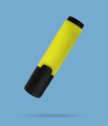 Image of Bright yellow marker falling on pale light blue background