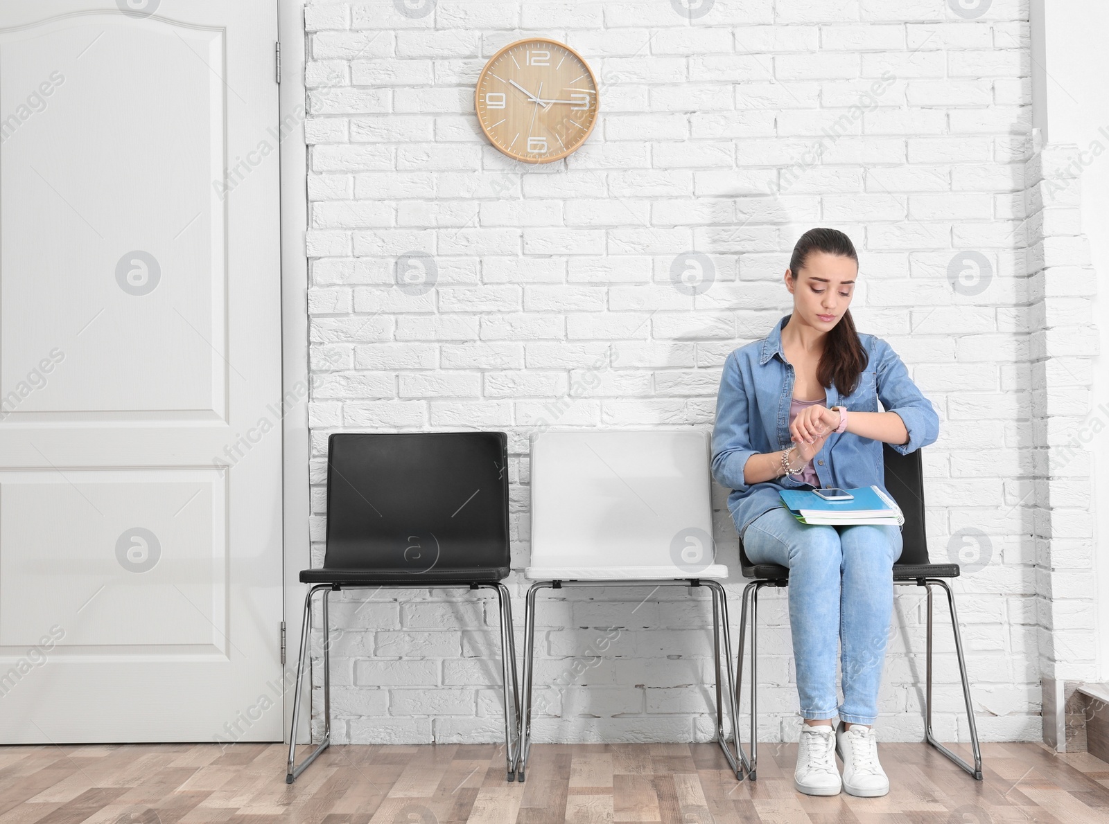 Photo of Young woman waiting for job interview, indoors