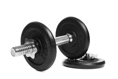 Photo of Professional dumbbell and weight plate on white background. Sporting equipment