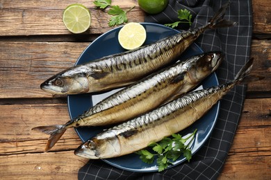 Tasty smoked fish on wooden table, flat lay