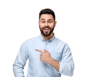 Happy young man with mustache pointing at something on white background