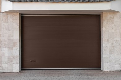 Brown modern counterweight garage doors on building