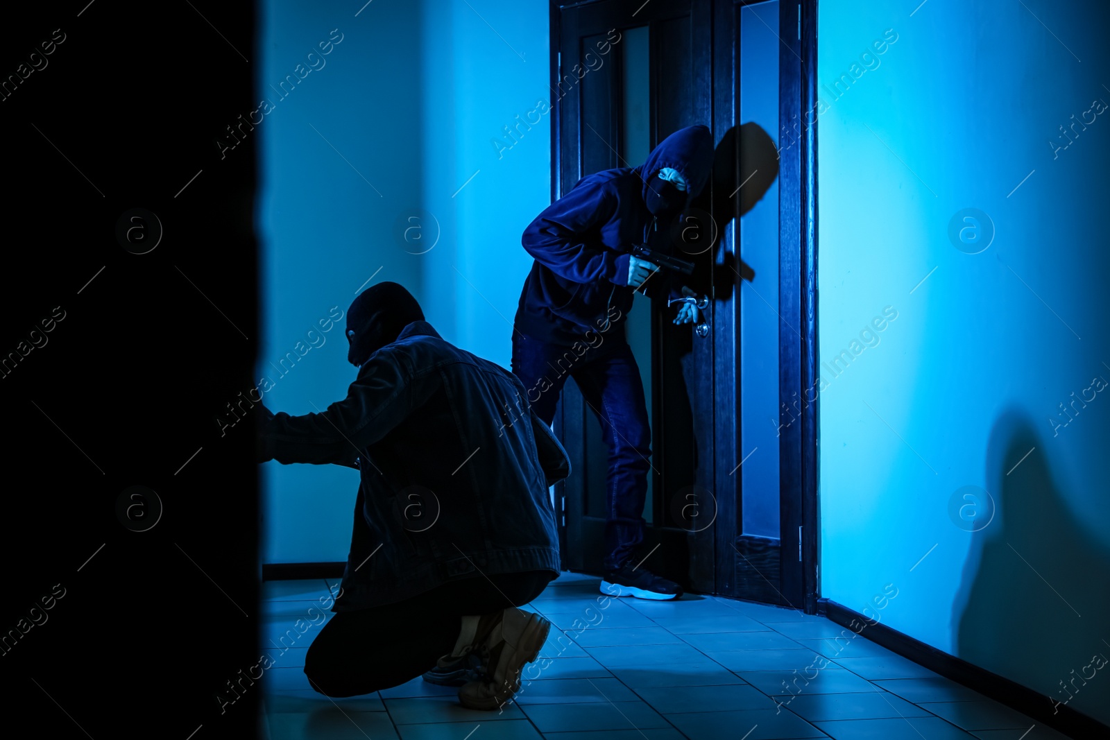 Photo of Dangerous criminals with gun and crow bar intruding into apartment