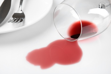 Photo of Composition with spilled wine on white background