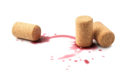 Photo of Bottle corks with wine stains on white background