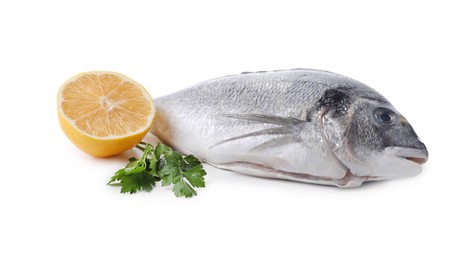 Raw dorado fish, lemon and parsley isolated on white