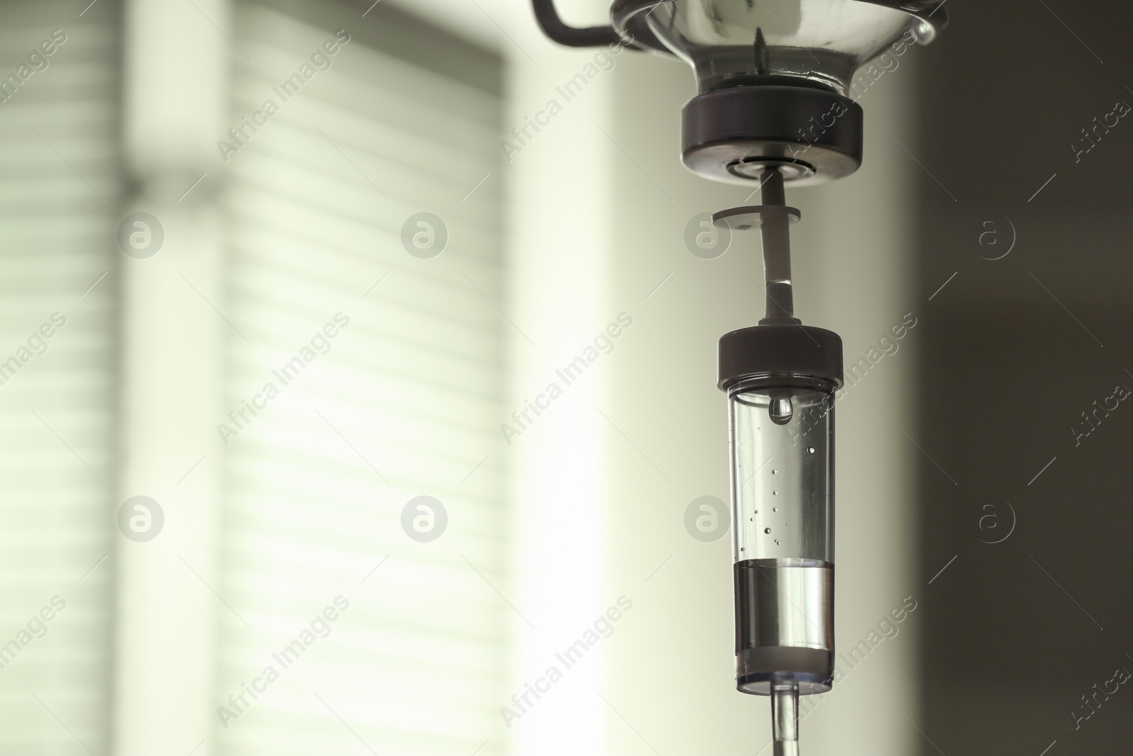 Photo of IV drip against blurred background, space for text