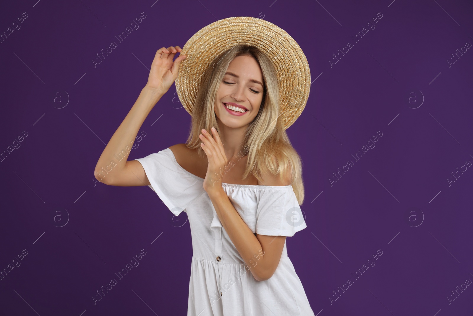 Photo of Young woman wearing stylish white dress on purple background