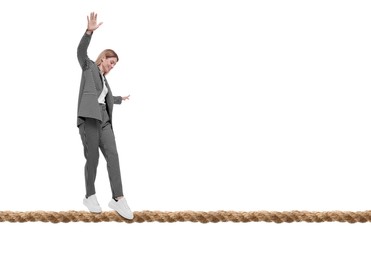 Businesswoman walking rope against white background. Risk or balance concept