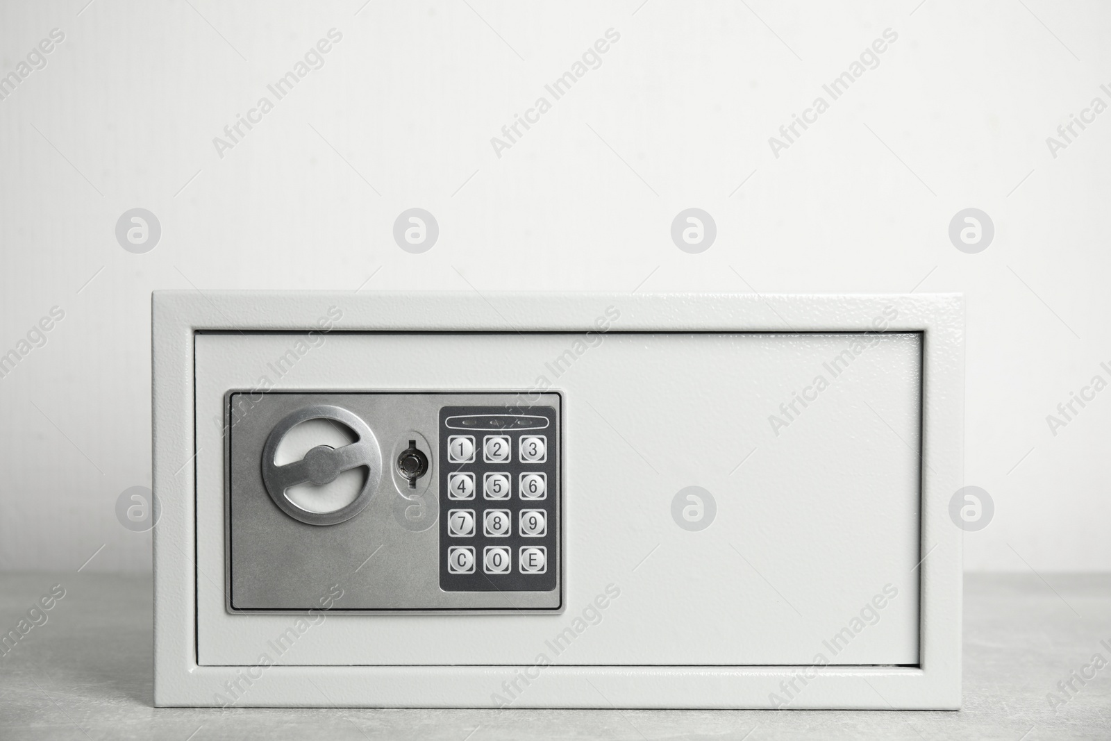 Photo of Steel safe with electronic lock on white background