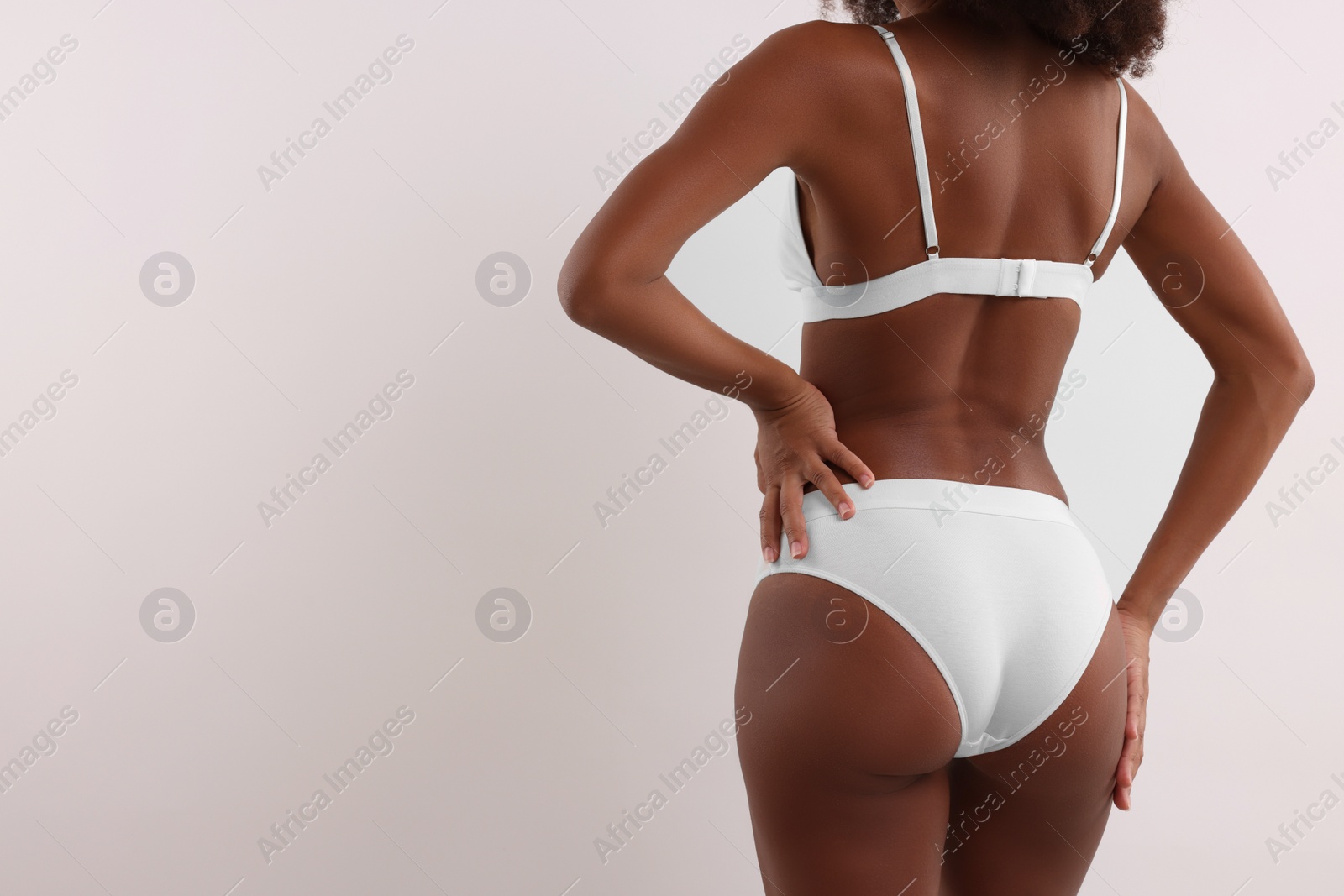 Photo of Woman in stylish bikini on white background, closeup. Space for text