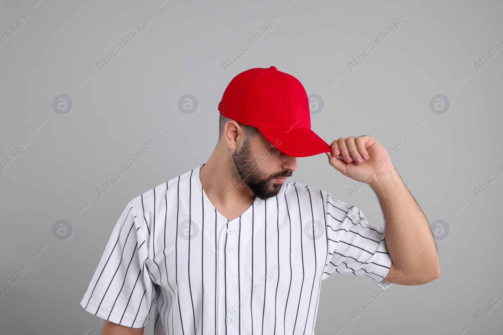 Photo of Man in stylish red baseball cap on light grey background