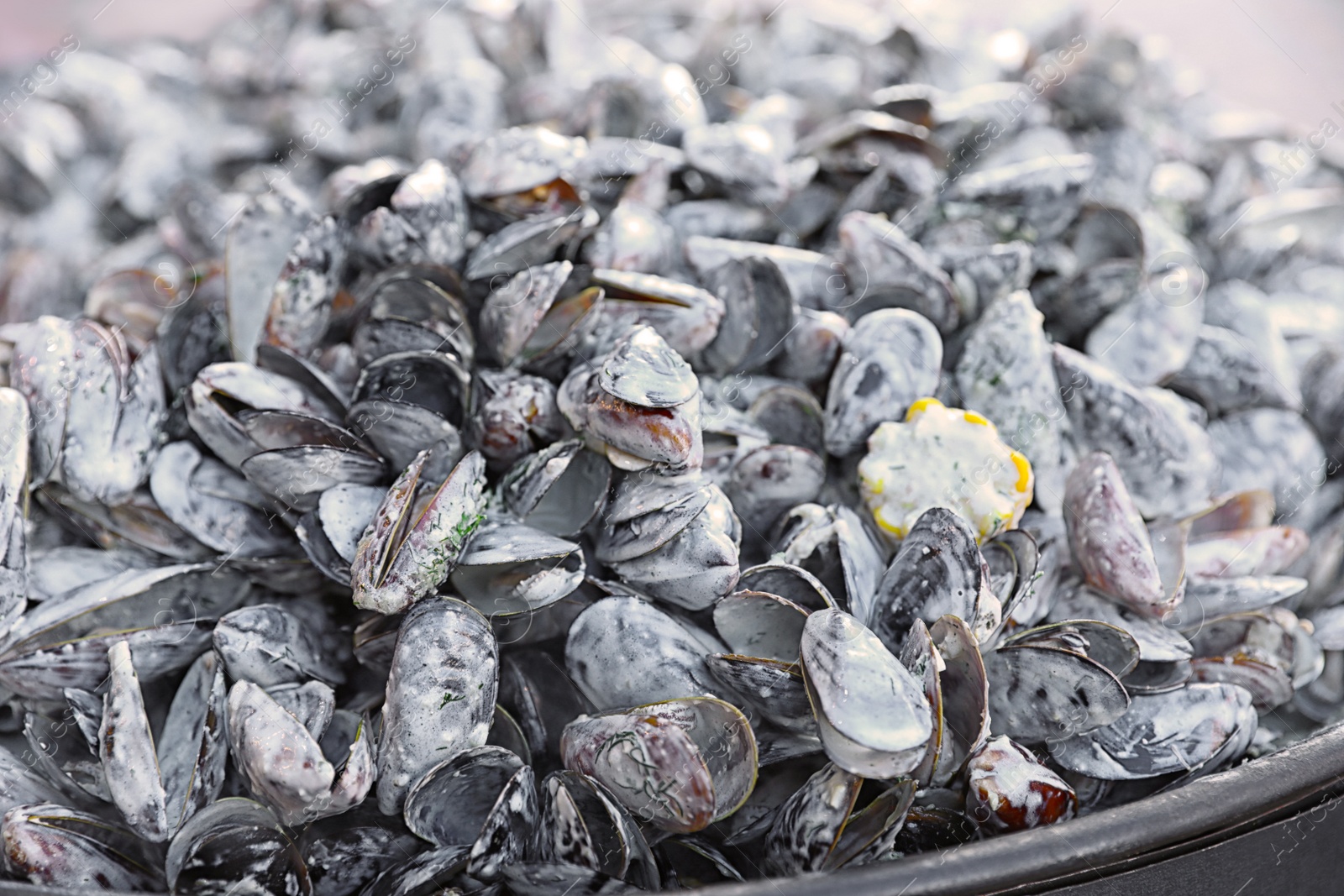 Photo of Delicious fresh mussels with sauce in pan, closeup