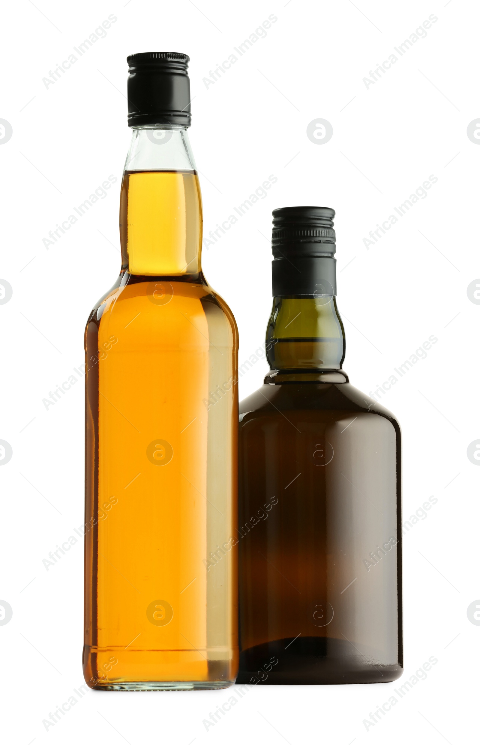 Photo of Different sorts of whiskey in glass bottles isolated on white