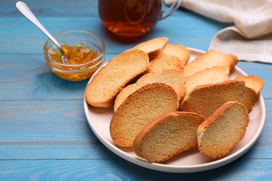 Photo of Hard chuck crackers and jam on light blue wooden table