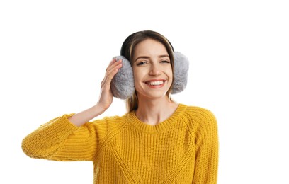 Photo of Happy woman wearing warm earmuffs on white background