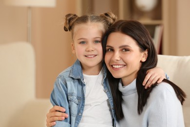 Photo of Little girl with her mother spending time together at home