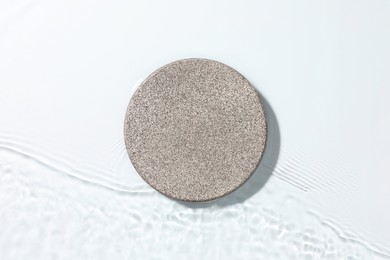 Photo of Presentation for product. Stone podium in water on white background, top view